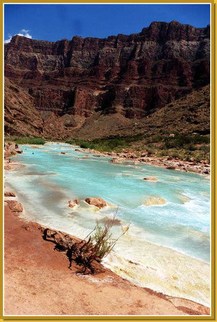 The turquoise waters of the Little Colorado River flow into the large Colorado River.