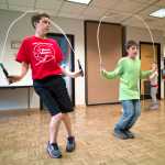 Juneau Jumper Garrett Klein, 12, left, shows Layne Cutnose, 12, some jumping pointers during a Wellness Wednesdays program at the Douglas Library on Wednesday.