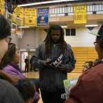 Seattle Seahawks offensive tackle Terry Poole signs autographs at Barrow High School on July 6 during a visit to meet with special olympians.