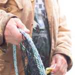 Edward Peele carefully untangles the beach seine at Eek Inlet. Photo by Bethany Goodrich.