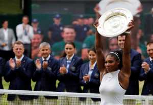 Serena Williams raises the trophy after beating Angelique Kerber of Germany in the women's singles final at the Wimbledon Tennis Championships on Saturday in London.