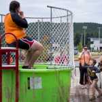 Torben Higgins, 7, right, throws a ball at the dunk tank lever as Julie Jackson, left, aquatics manager for the City and Borough of Juneau, awaits a dunk at the 6th Annual Rotary Day at the Pool at the Dimond Park Aquatic Center on Saturday afternoon. The pool held three free swims, with over 100 attendees at each swim.