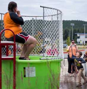 Torben Higgins, 7, right, throws a ball at the dunk tank lever as Julie Jackson, left, aquatics manager for the City and Borough of Juneau, awaits a dunk at the 6th Annual Rotary Day at the Pool at the Dimond Park Aquatic Center on Saturday afternoon. The pool held three free swims, with over 100 attendees at each swim.
