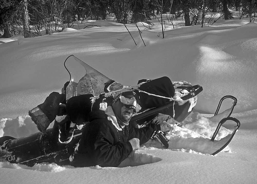 Seth Kantner, fellow arctic writer, photographer and longtime traveling companion, struggles with a stuck snowmobile on the way to the Arrigetch Peaks.