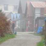 People chat in Tenakee Springs on a foggy fall day.