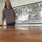 Reid Harris, owner of Northern Edge Craftworks, creates live-edge tables, benches, and other furnishings using locally sourced, sustainable wood. On the underside of each piece, he even stamps the GPS location where the tree was harvested. A show of his work will be up at The Canvas at REACH until July 26. This table incorporates live edge covered by glass, which is reflecting a piece of art by Abe Wylie. Mary Catharine Martin | Capital City Weekly