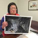 Grace Coenraad with one of her pieces of art. This one incorporates markers, graphite and ink. Mary Catharine Martin | Capital City Weekly