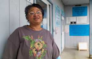 Cecilia Welch stands outside her temporary housing at St. Vincent de Paul on Wednesday. Welch's apartment suffered water damage during a fire at the Channel View Apartments on April 11.