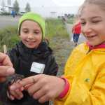 Trinitey Landry and Anna Rozell watch a dragonfly caught at UAF Summer Sessions Bug Camp on the UAF campus.