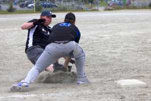 Third baseman for  Thibideau's Kenny's Liquor, Chad Dubois, lays down a tag on Nick Andrews from Sitka team E.L.I. during the 41st annual Jamie Parsons Rainball Tournament on Saturday.
