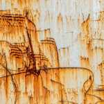 Rust patterns on an old transport container.