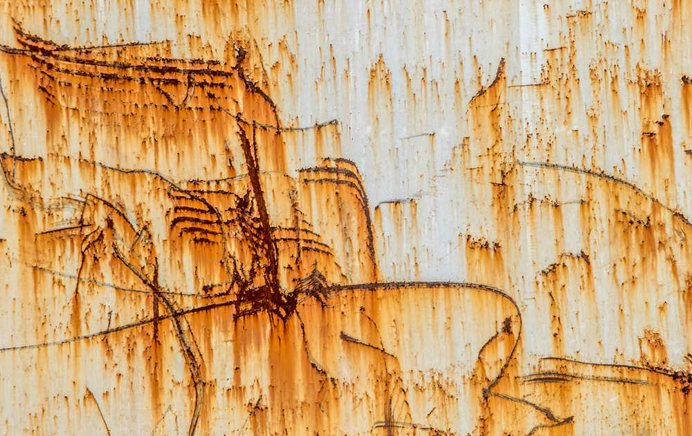 Rust patterns on an old transport container.