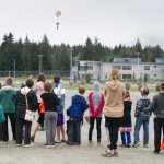Children and their parents watch a rocket return to the ground during Science Friday at the Mendenhall Valley Public Library on Friday. The event was made possible by the Juneau Public Library and the Seattle Museum of Flight.