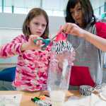 Kate Stickel, 8, left, and Ava Furuness, 11, learn how to make a rocket during Science Friday at the Mendenhall Valley Public Library on Friday. The event was made possible by the Juneau Public Library and the Seattle Museum of Flight.