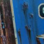 Detail from a great white shark sculpture made from the rusting sides of a fishing boat. Chatham Village, Cape Cod, July 2016.