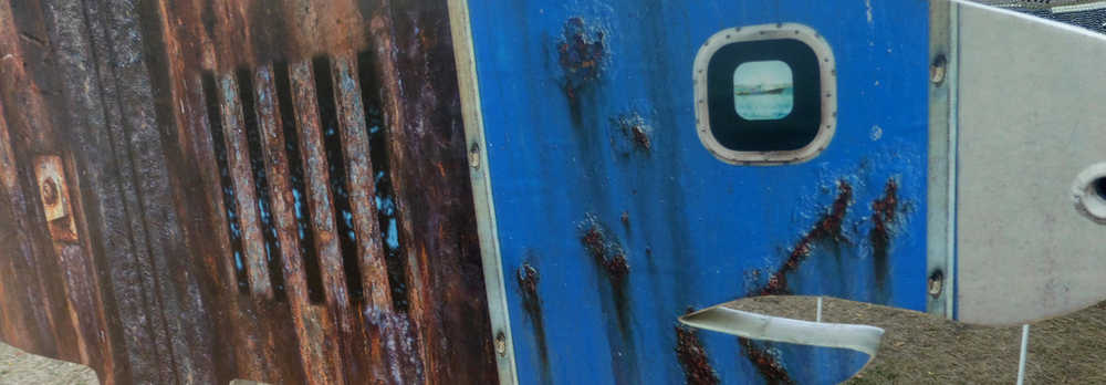 Detail from a great white shark sculpture made from the rusting sides of a fishing boat. Chatham Village, Cape Cod, July 2016.