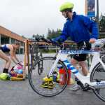 Kathy Kartchner, right, starts her 12-mile ride as Teresa Svancara, makes the transition from swimming to bicycling during their triathlon camp at the University of Alaska Southeast campus on Tuesday.
