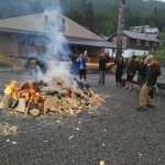 Community members heat up large rocks in a big fire on July 27. To steam the canoe open, they place the hot rocks in the canoe, which is partly filled with seawater and covered.