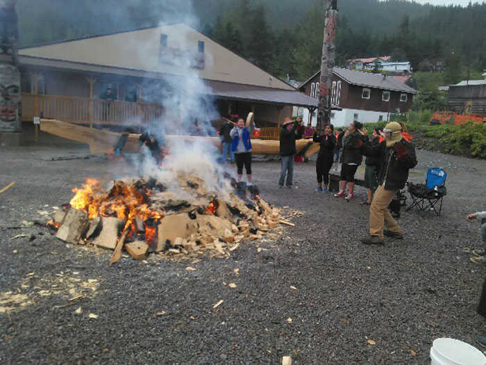 Community members heat up large rocks in a big fire on July 27. To steam the canoe open, they place the hot rocks in the canoe, which is partly filled with seawater and covered.
