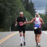 Richard DeCample receives a high five from a runner during the Frank Maier Marathon.