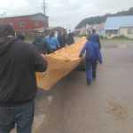 Hoonah community members carry the second of two forty-foot spruce dugout canoes, successfully steamed open July 27, 2016.