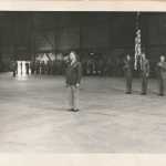 An unknown ceremony inside a very clean hangar bay.