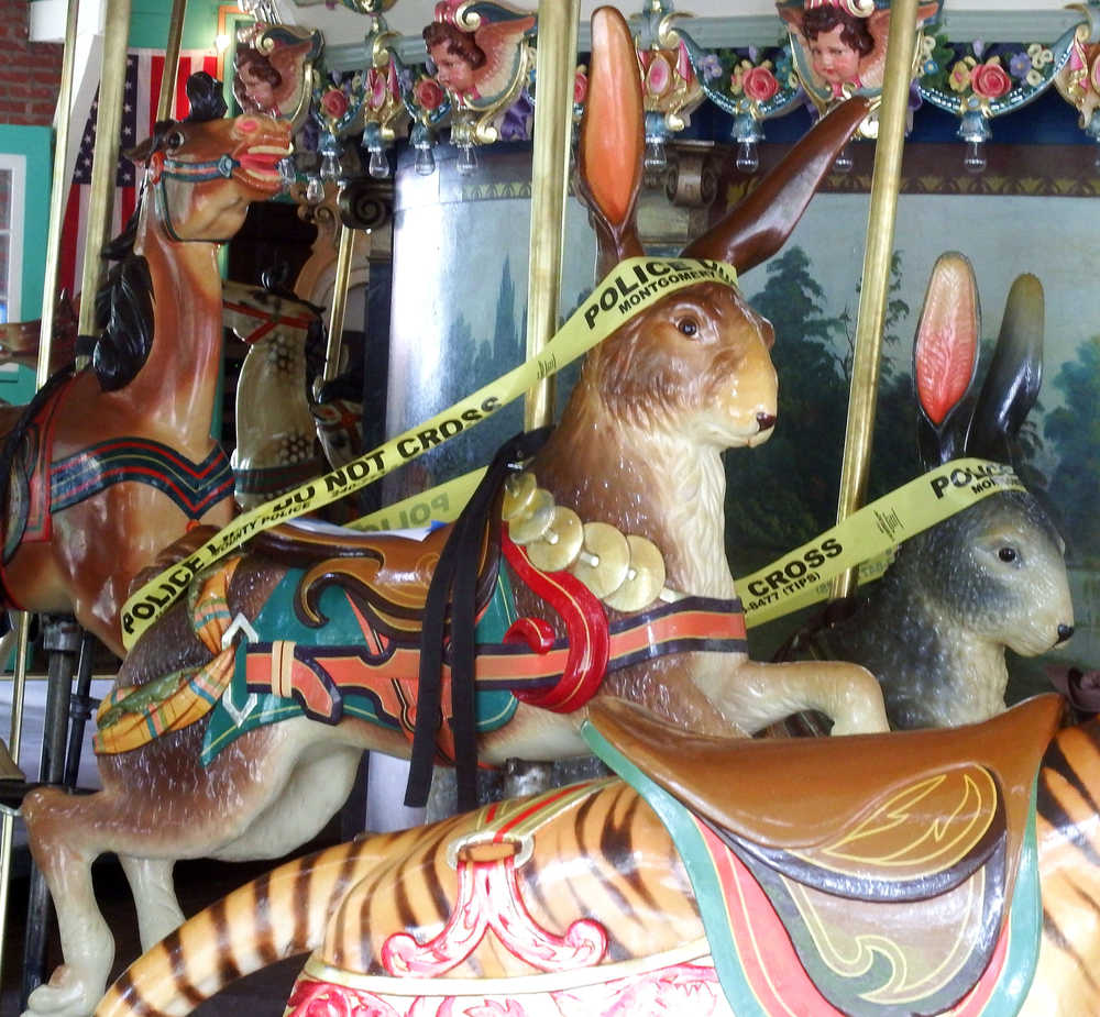 Glen Echo Park Dentzel carousel bunnies decorated in police tape in late May, Maryland.  Dentzel carousel is one of the oldest continuously operating carousels in the U.S.