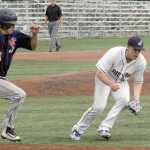 Josh Darrow tries to beat out a single with Juneau pitcher Phil Wall in pursuit Friday at Mulcahy Stadium in Anchorage.