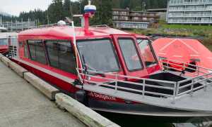 A 25-person inflated life-boat sits next to a Dolphin Jet Boat Tours whale-watching boat tied up at the Statter Memorial Boat Harbor in Auke Bay on Monday. One of the companies boat sunk on the south end of Aaron Island on Sunday. Eighteen people were rescued with one minor injury reported.