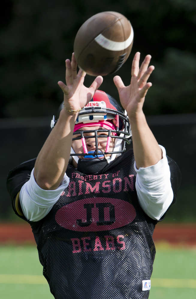 John Williams catches a pass during Juneau-Douglas High School varsity football practice at Adair-Kennedy Memorial Park on Wednesday.