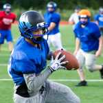 Gabe Crawford catches a pass during varsity football practice at Thunder Mountain High School on Wednesday.