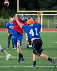 Quarterback Calen Jenkins passes during varsity football practice at Thunder Mountain High School on Wednesday.