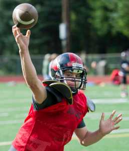 Quarterback Bubba Stults passes the ball during Juneau-Douglas High School varsity football practice at Adair-Kennedy Memorial Park on Wednesday.