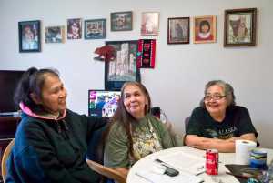 Sisters Laura Sheldon, Myrna Brown and Maureen Brown (left to right) gather at Maureen's apartment to plan a community event at Twin Lakes on Sunday from 2-5:30 p.m. for families across Juneau to gather and focus on healing and culture. The three sisters are also working on their own healing - each woman has lost one or more of her children to violent deaths in different Alaska cities.