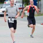Kenny Fox out sprints Justin Dorn at the finish line of the 8th annual Aukeman Sprint Triathlon at the University of Alaska Southeast on Saturday.