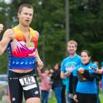 Mick Bakker of Anchorage pumps a fist as he crosses the finish line in the 8th annual Aukeman Sprint Triathlon at the University of Alaska Southeast on Saturday.