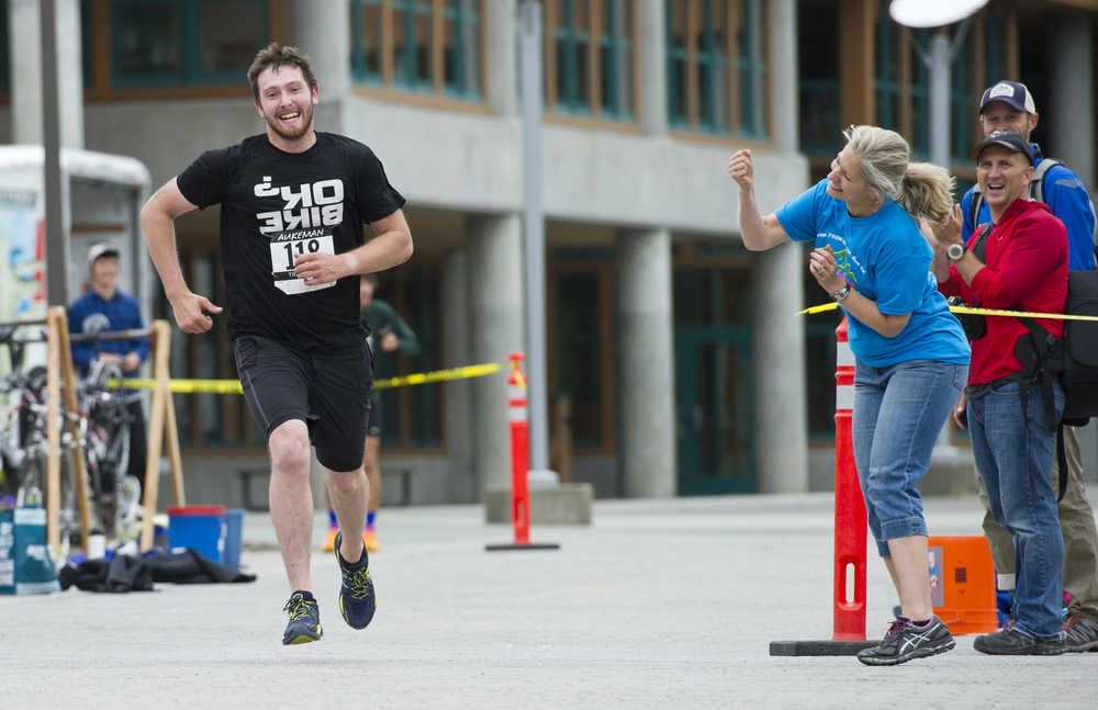 Derec Steinman receives some encouragement as he starts the run portion of the 8th annual Aukeman Sprint Triathlon at the University of Alaska Southeast on Saturday.