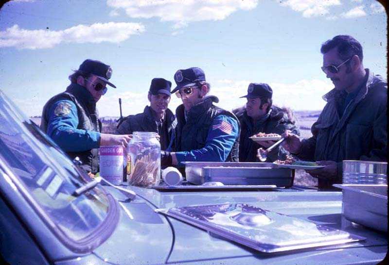 Federal marshals eat in the field during the first week of the siege at Wounded Knee. Paul and Virginia Berg, later along with others, cooked and brought food for the FBI and the marshals.