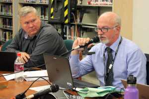 Juneau School District Superintendent Mark Miller speaks during Tuesday night's regular school meeting as board member Emil Mackey looks on. It was the school board's first meeting of the new school year.