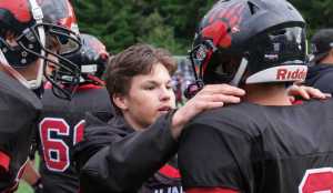 Crimson Bears players rally on the sideline during Saturday's game against Thunder Mountain. TMHS won 50-20.