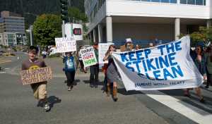 In this Aug. 27, 2015 photo, protesters march down Main Street after a rally on the steps of the Alaska State Capitol to bring attention to the long-term protection of transboundary waters, principally the Taku, Stikine and Unuk watersheds.