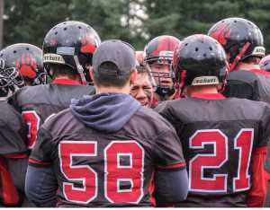 The Crimson Bears huddle during a game Aug. 13 against Thunder Mountain High School. The team will face the Kodiak High School Bears at 6 p.m. Friday at Adair Kennedy Field.