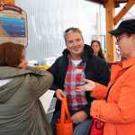 Juneau Food Tours owner Midgi Moore talks to two of her customers at Tracy's King Crab Shack, the first tasting of the day.
