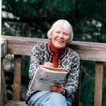 Rie smiles as she gets her picture taken while working on her art.