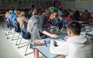 Chemistry teacher Topaz Shryock helps one of over thirty students at Thunder Mountain High School on Tuesday. The school added another chemistry class this week to get the class sizes down to the low-twenties.