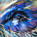 Colors of the aurora surround the eye of a life-size, fiberglass bear statue at a visitors center on Thursday, Aug. 25, 2016, in Anchorage, Alaska. The painted statues, part of "Bears on Parade," were installed to increase awareness of grizzly and black bears that live within the municipality of Anchorage and to highlight an international bear conference hosted by the city. (AP Photo/Dan Joling)