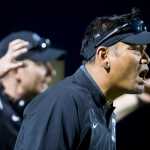 Thunder Mountain's Head Coach Randy Quinto, right, yells encouragement to his team as they play against Kenai High School at TMHS on Friday. Kenai won the game 23-12.