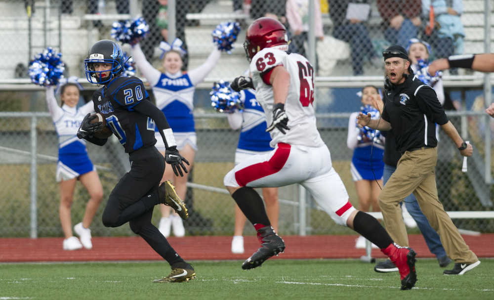 Thunder Mountain's Jacob Tapia, left, runs an interception for a touchdown against Kenai High School at TMHS on Friday. Kenai won the game 23-12.