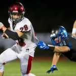 Kenai's Rykker Riddall breaks a tackle attempt by Thunder Mountain's Jaspa Palffy at TMHS on Friday. Kenai won the game 23-12.