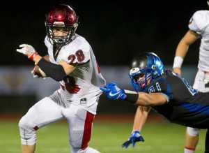 Kenai's Rykker Riddall breaks a tackle attempt by Thunder Mountain's Jaspa Palffy at TMHS on Friday. Kenai won the game 23-12.